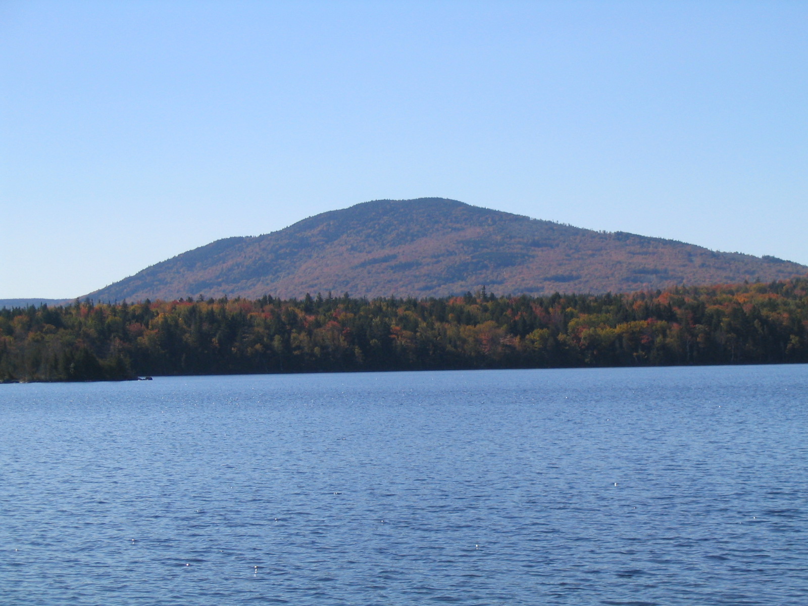 13.7 MM. Round Top Mountain holds sentinel over West Carry Pond. This was a spectacular autumn day.  We ate lunch here while enjoying this vista from the lakeshore. Courtesy askus3@optonline.net